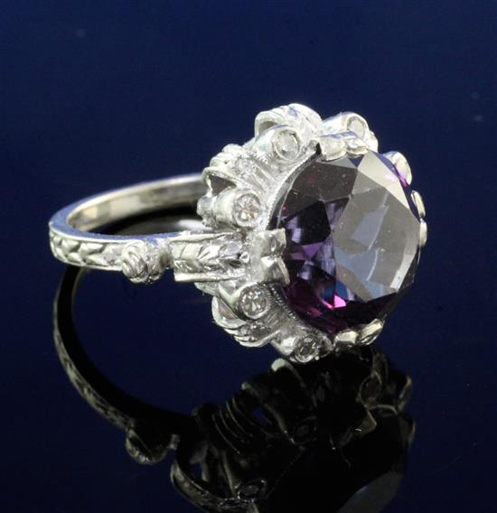 A modern white gold, synthetic colour change corundum and diamond cluster dress ring, size P.